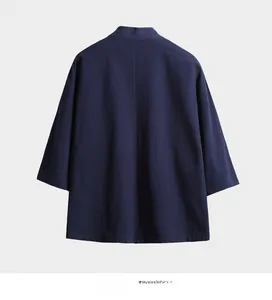 Macro shot showing the natural texture of dark blue linen fabric on a kimono cardigan