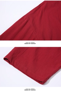 Detailed macro view of dark red linen fabric texture and stitching on Chinese cardigan