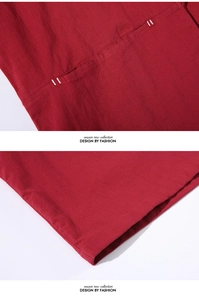 Macro detail of dark red linen fabric showing neat white stitching on pocket and hem