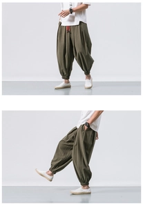 Detail of olive green linen joggers with contrast red drawstring and elastic ankle cuffs