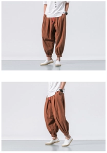 Detail of brown linen harem pants with elastic waist and red drawstring closure