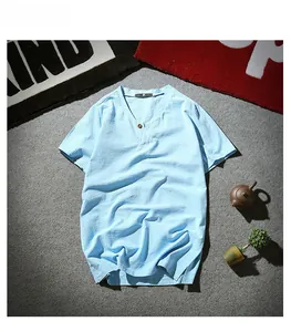 Detail of light blue linen-blend Henley shirt with V-neck and single wooden button texture
