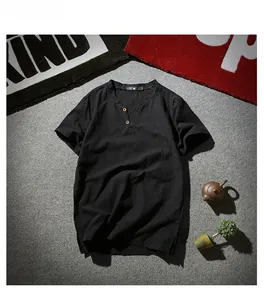 Detail of black cotton linen Henley shirt with V-neckline and two buttons on grey texture