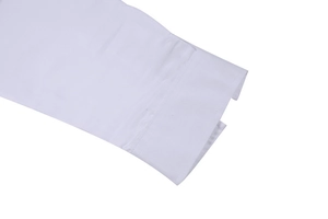 Close-up of white long sleeve shirt cuff showing premium stitching and woven fabric