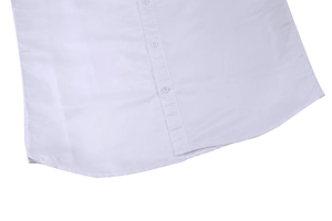 Detail of the curved hem and white resin buttons on a slim-fit business shirt