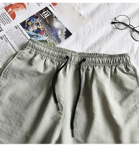Detail view of men's casual shorts with elastic drawstring waistband and metal tips