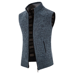 Detailed close-up of blue knitted men's vest with stand collar and plaid lining fleece