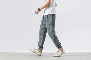 Detailed view of greyish-blue linen jogger pants featuring drawstring waist and elastic cuffs