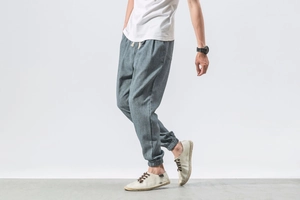 Detail view of grey-blue linen harem pants with adjustable drawstring and cuffed ankles