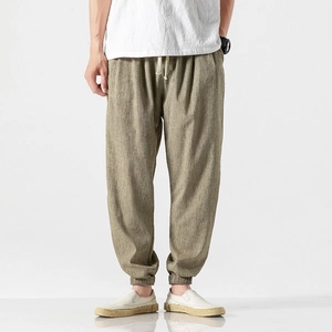 Close-up of gray-green cotton linen lantern pants showing fabric texture and drawstring waist