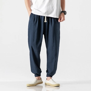 Detail of navy linen jogger pants featuring drawstring waist and ribbed cuffs for men