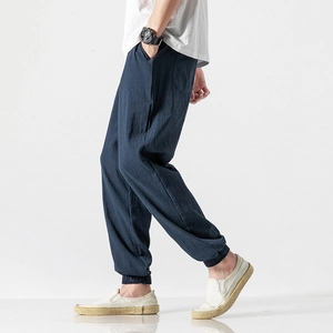 Detail of navy linen harem pants for men showing elastic cuffs and relaxed fit design