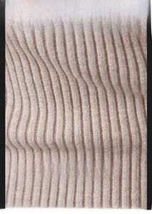 Close-up of high-density ribbed knit fabric in beige, showing texture and durability