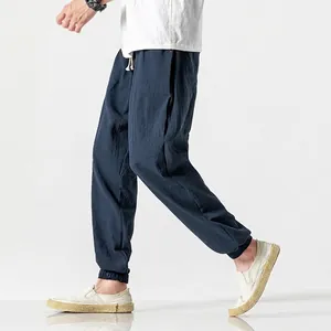 Men's dark blue linen harem pants with elastic drawstring waist and tapered ankle cuffs