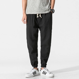 Men's loose linen harem pants with drawstring elastic waist and tapered ankle cuffs