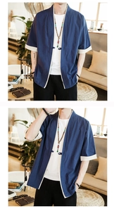 Detail of royal blue cotton linen kimono jacket with ivory contrast trim and bead charm