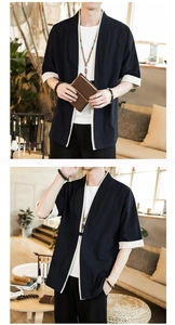 Detailed close-up of a navy linen kimono cardigan with contrast beige trim and natural texture