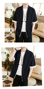 Detail of navy blue men's kimono cardigan with off-white trim and Chinese frog button