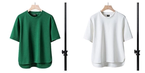 Detail of high-low curved hem and piqué fabric texture on loose fit short sleeve t-shirt