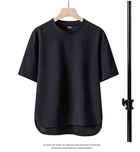 Detail view of black loose-fit T-shirt showing round neck and irregular curved hemline