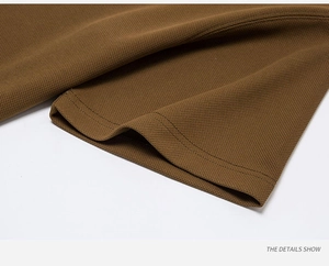 Detail of brown cotton pique polo shirt sleeve with durable double-stitch sewing