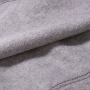 Macro shot of thick light grey fleece fabric texture for thermal men's long sleeve shirts