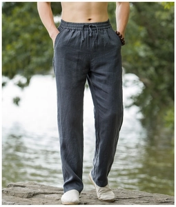 Detail of dark grey linen trousers featuring elastic waistband and drawstring for men