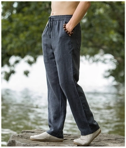 Detail of loose fit cotton linen trousers with elastic drawstring waist for casual men's style