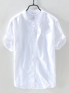 Detail view of white linen cotton shirt showing Mandarin collar and 100% cotton inner tag