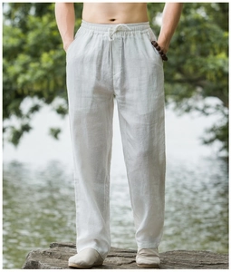 Detail of white cotton linen pants showing elastic waistband and drawstring texture