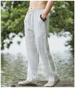 Detail of white linen blend wide-leg pants featuring an elastic drawstring waist for men