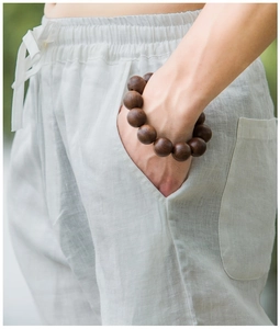 Close-up of a men's wooden bead bracelet made of 12 polished dark brown beads