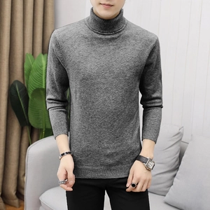 Dettaglio del maglione grigio a dolcevita con trama a maglia fine e polsini a costine