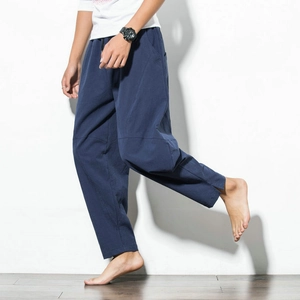 Detail of navy cotton linen trousers featuring drawstring waist and side split hem