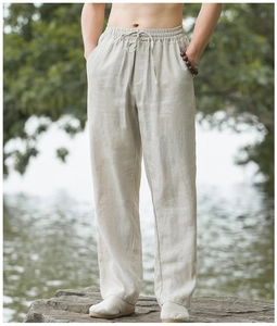 Close-up of drawstring waist on men's linen blend trousers with rustic texture