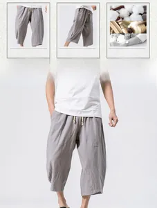 Detail of grey men's linen cropped pants featuring elastic drawstring waist and loose fit