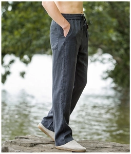 Close-up of dark grey linen trousers featuring an elastic drawstring waist and natural texture