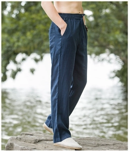 Detailed view of the dark blue linen fabric texture and drawstring elastic waistband on pants