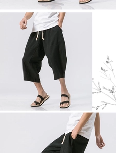 Detail of men's black linen cropped pants with drawstring waist and breathable fabric