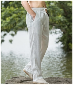 Men's linen trousers featuring elastic drawstring waist and loose straight-leg fit detail
