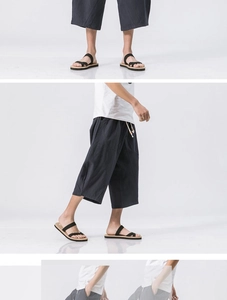 Detail of navy linen cropped pants featuring elastic drawstring waist and relaxed fit design