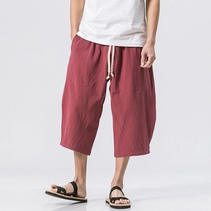 Loose linen cropped pants for men featuring a brick red color and drawstring waist