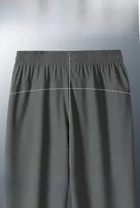 Detail view of the 3D ergonomic cut and elastic waistband on grey ice silk pants