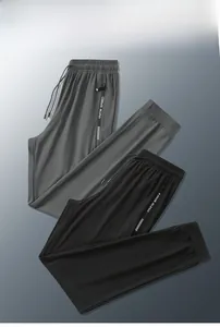 Detailed view of elastic waistband with drawstring and zipper pockets on sports joggers