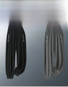 Detail of high-stretch ice silk jogger pants featuring elastic waistband and zip pockets