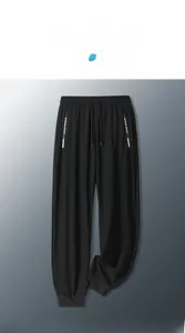 Detail of men's ice silk trousers with elastic waist, drawstring, and NEW SPORT print
