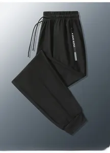 Detail view of black ice silk joggers featuring zipper pockets and elastic drawstring waist