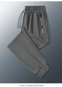 Detail view of dark grey ice silk jogger pants with drawstring waist and NEW SPORT logo