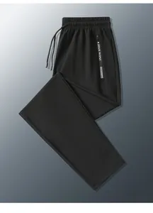 Close-up of elastic waistband with drawstring and zipper pocket on ice silk pants