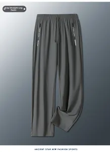 Close-up of grey ice silk trousers featuring zipper pockets and elastic drawstring waist